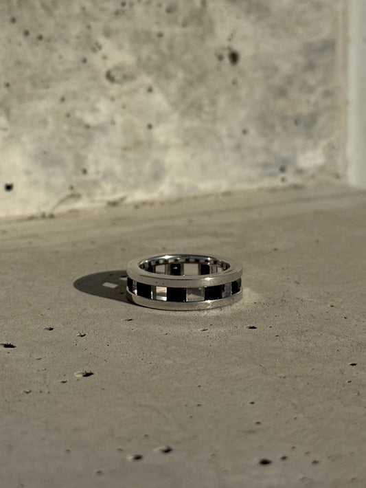 sterling silver eterniy, stackable band with black crystals lining the ring.